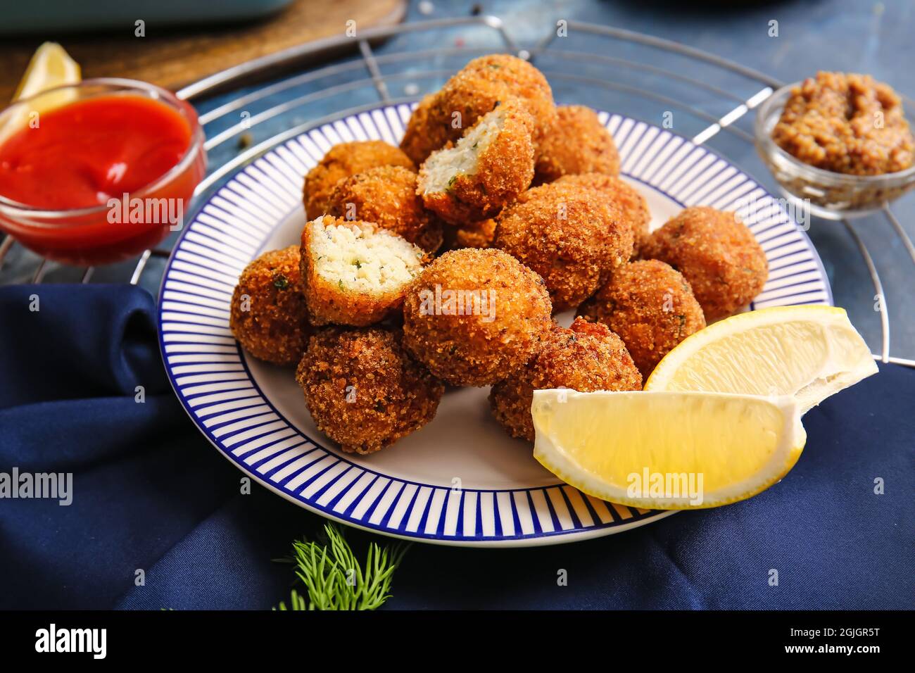 Cod Cutlets Plate with tasty cod cutlets and sauce on table, closeup Stock Photo ...