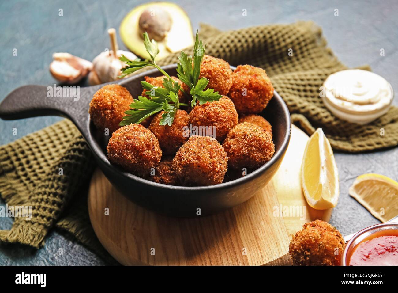 Frying pan with tasty cod cutlets on dark background, closeup Stock Photo