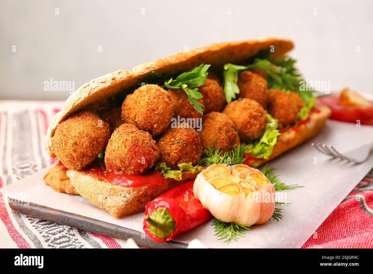 Board with bread and tasty cod cutlets on table, closeup Stock Photo