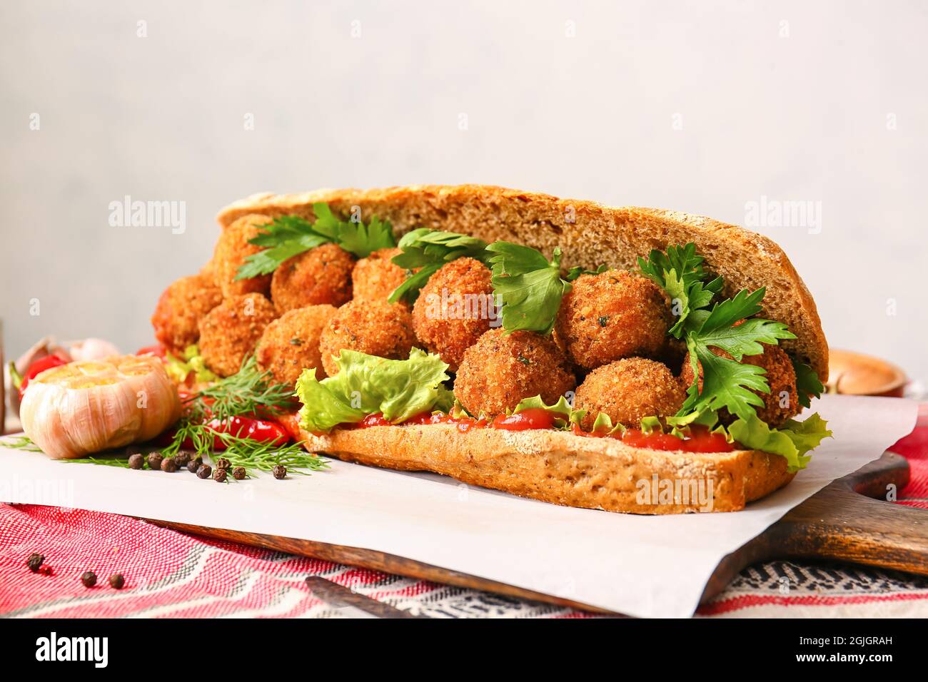 Board with bread and tasty cod cutlets on table Stock Photo
