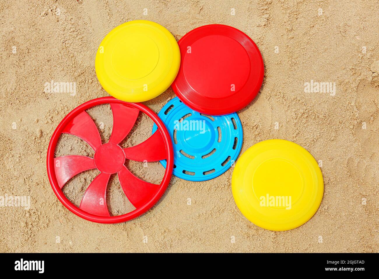 Different frisbee disks on sand Stock Photo Alamy