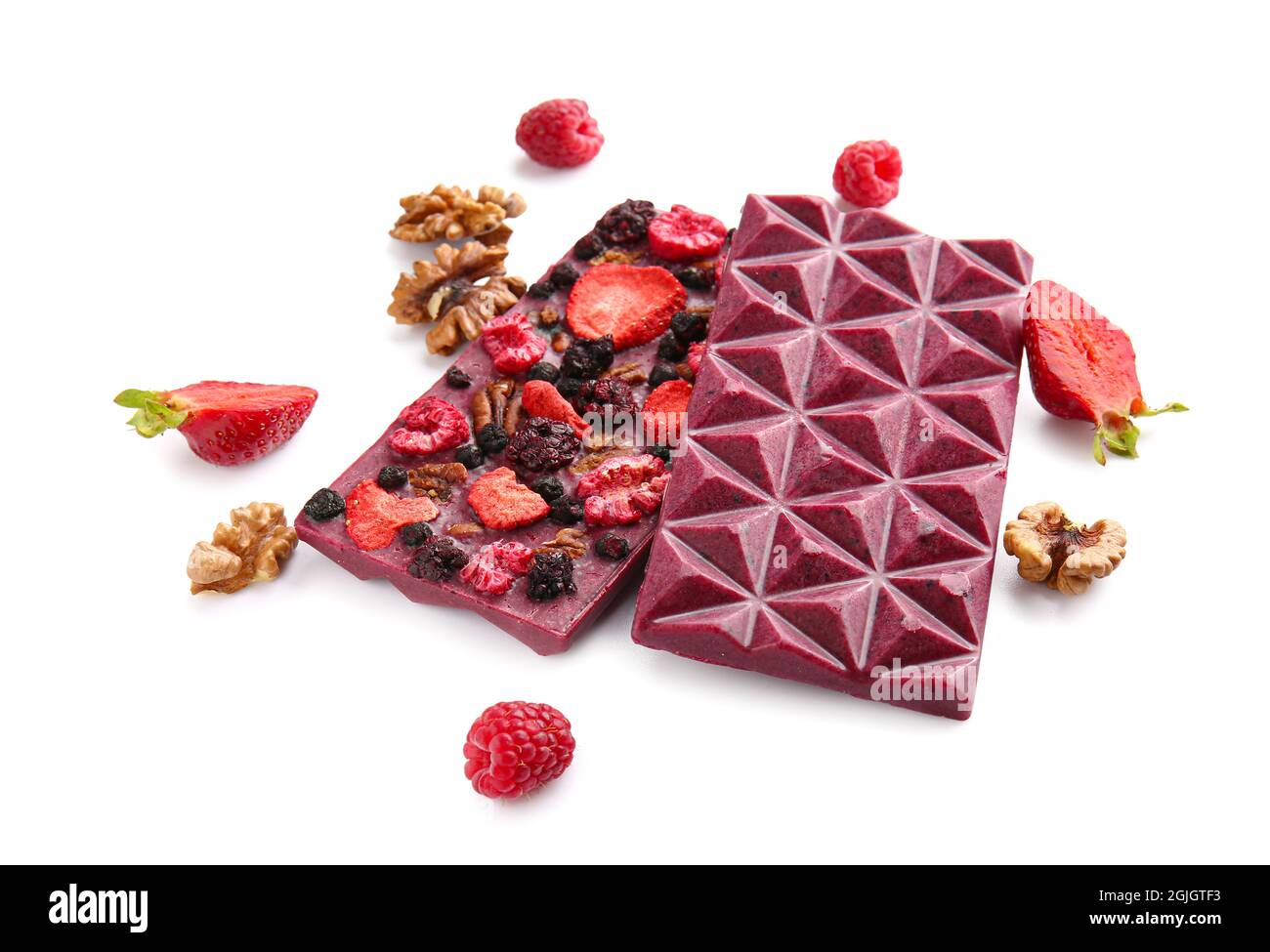 Handmade chocolate bars with fruits, berries and nuts on white ...
