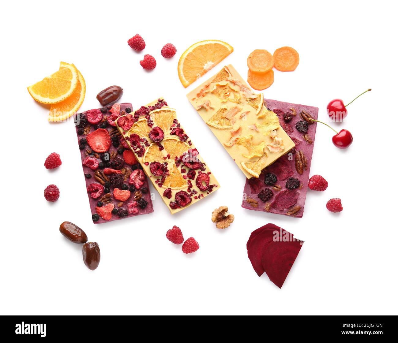 Handmade chocolate bars with fruits, berries and nuts on white ...