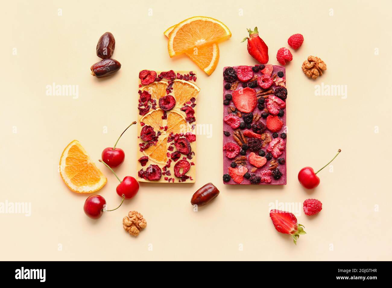 Handmade chocolate bars with fruits, berries and nuts on color ...