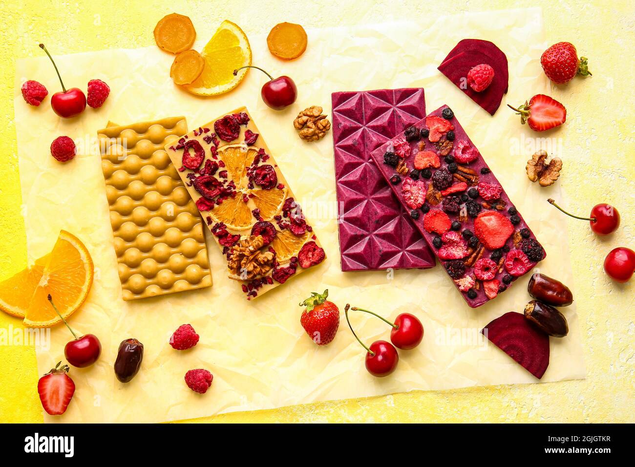 Handmade chocolate bars with fruits, berries and nuts on color ...
