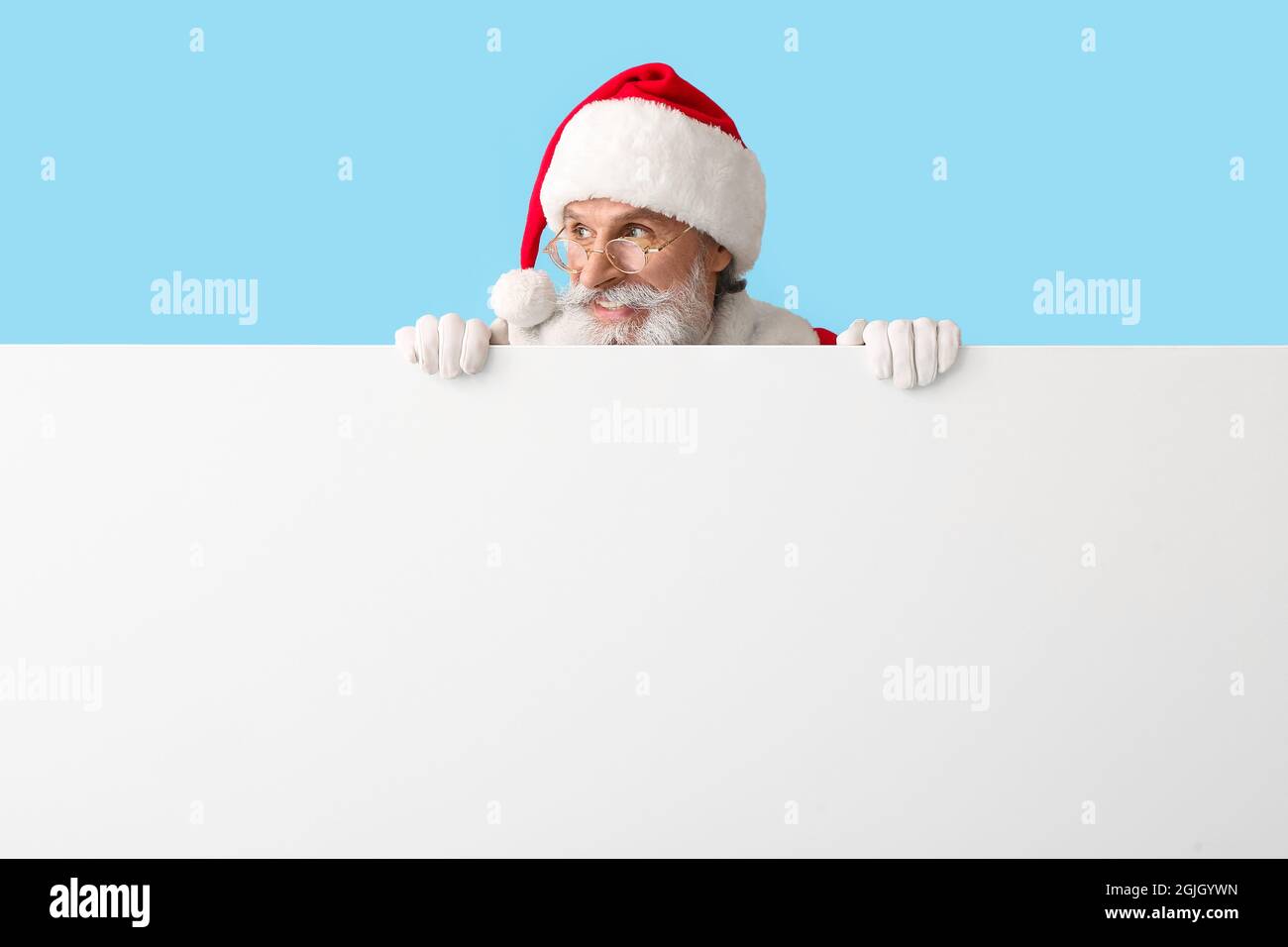 Santa Claus with blank poster on color background Stock Photo - Alamy