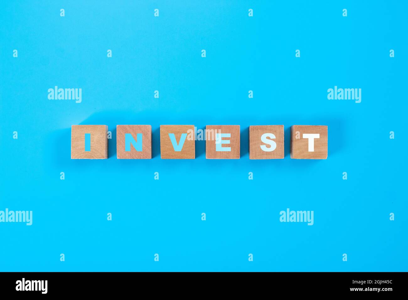 Text on square wooden blocks, investment concept ideas. Stock Photo