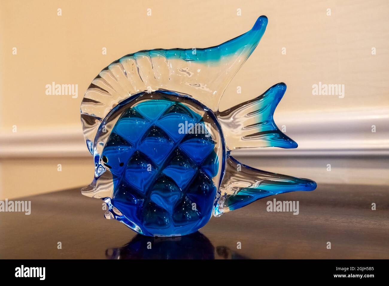 Fishshaped glass statue on a table Stock Photo Alamy