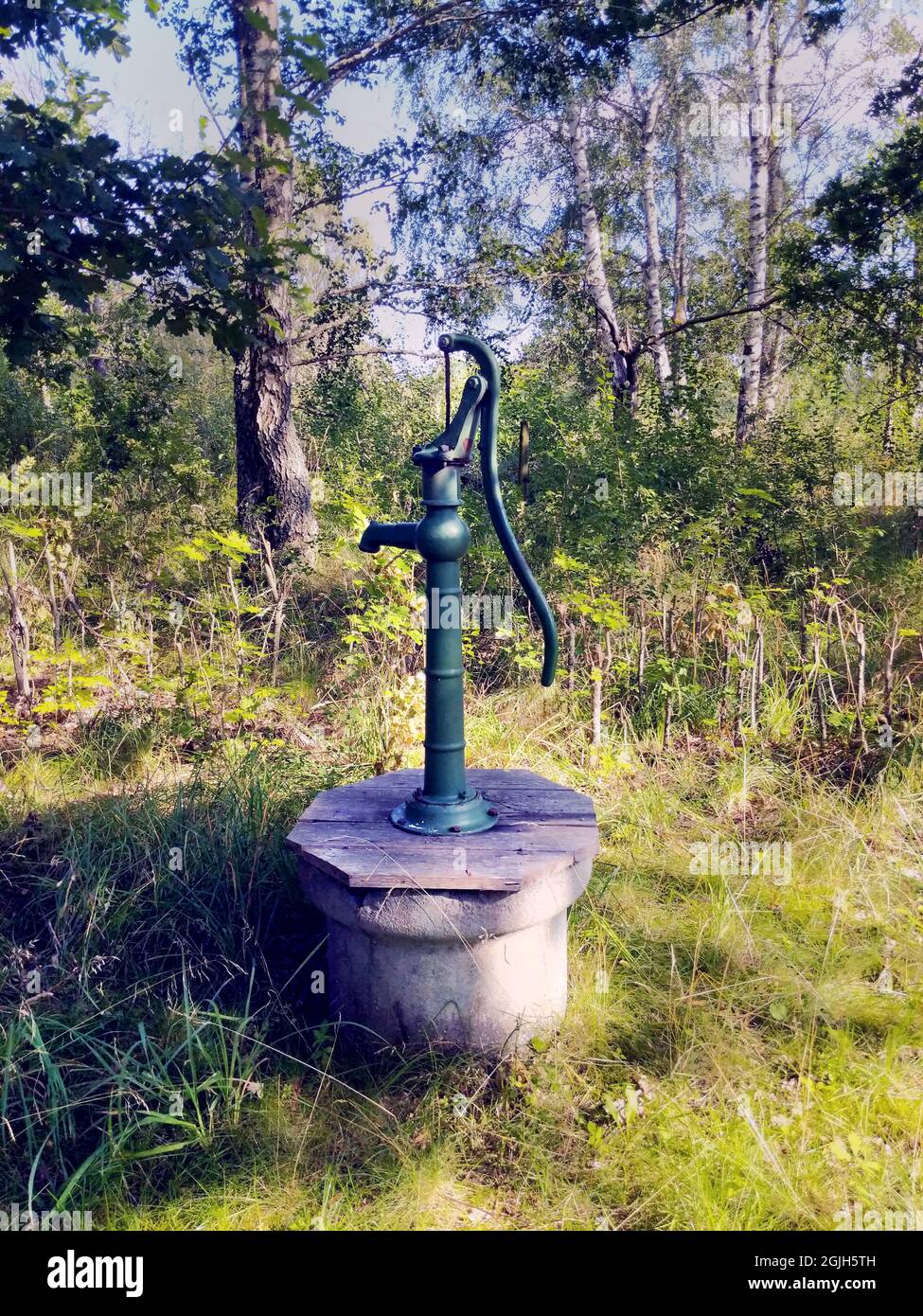 Old fashion outdoor well hand water pump Stock Photo - Alamy