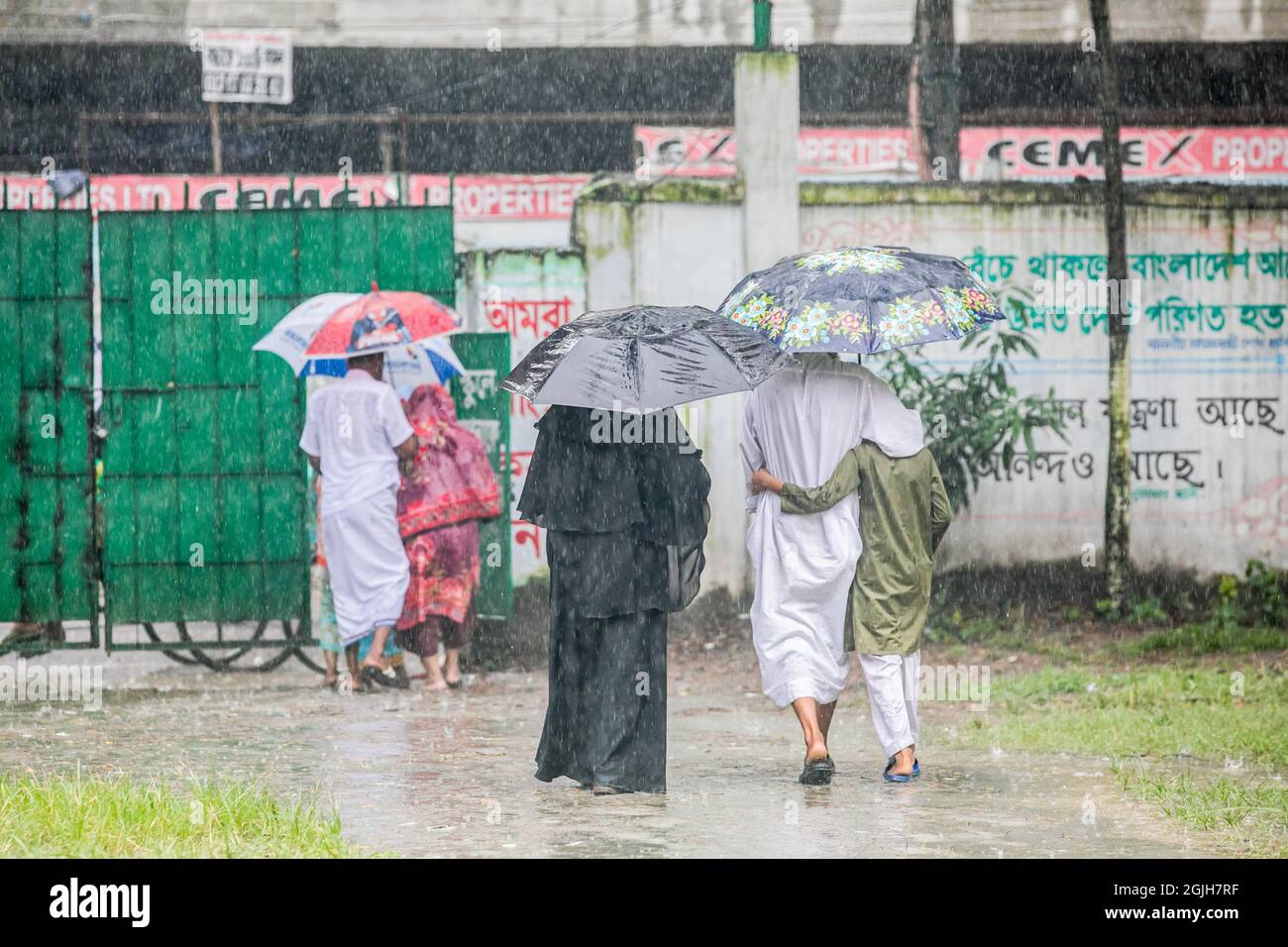 People seen shelter from the rain with an umbrella.Monsoon downpour