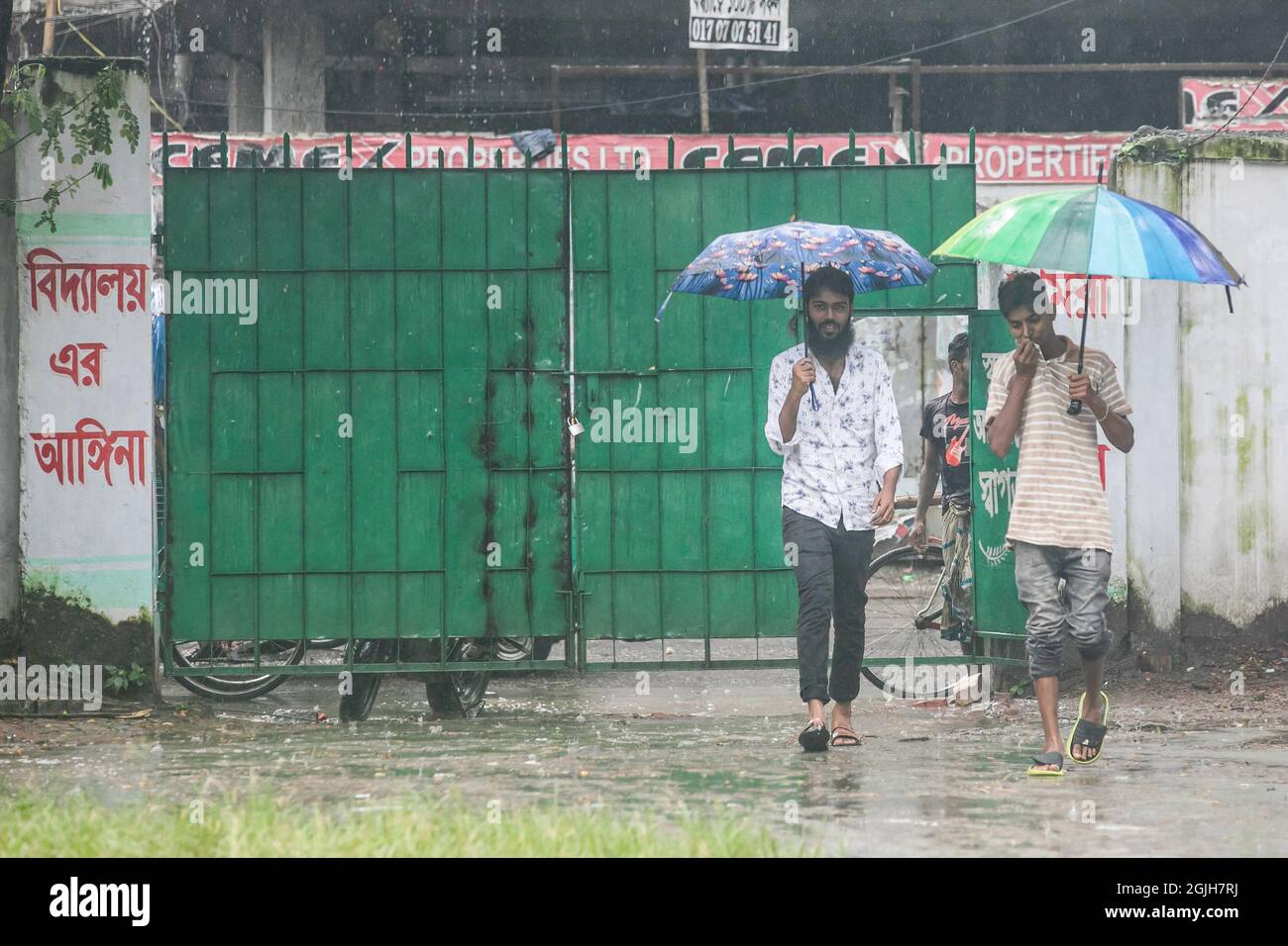 People seen shelter from the rain with an umbrella.Monsoon downpour