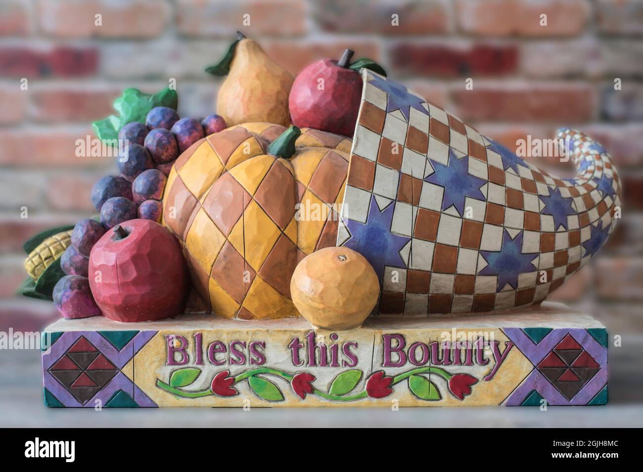 Decorative and colorful wooden horn of plenty with fruit and Thanksgiving concept blessing Stock