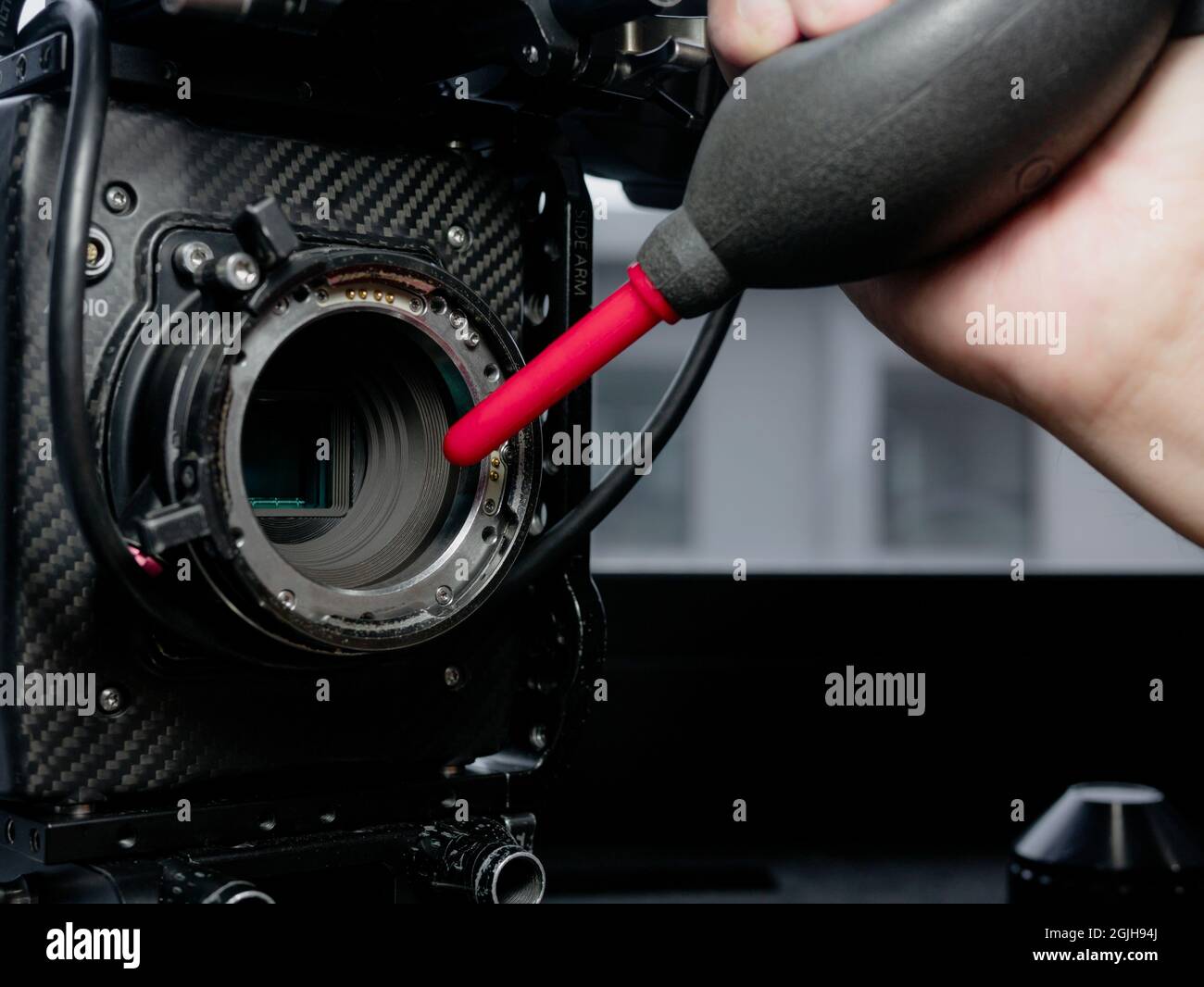 Close Up human hand using a rubber inflator o blow dust and clean the ...