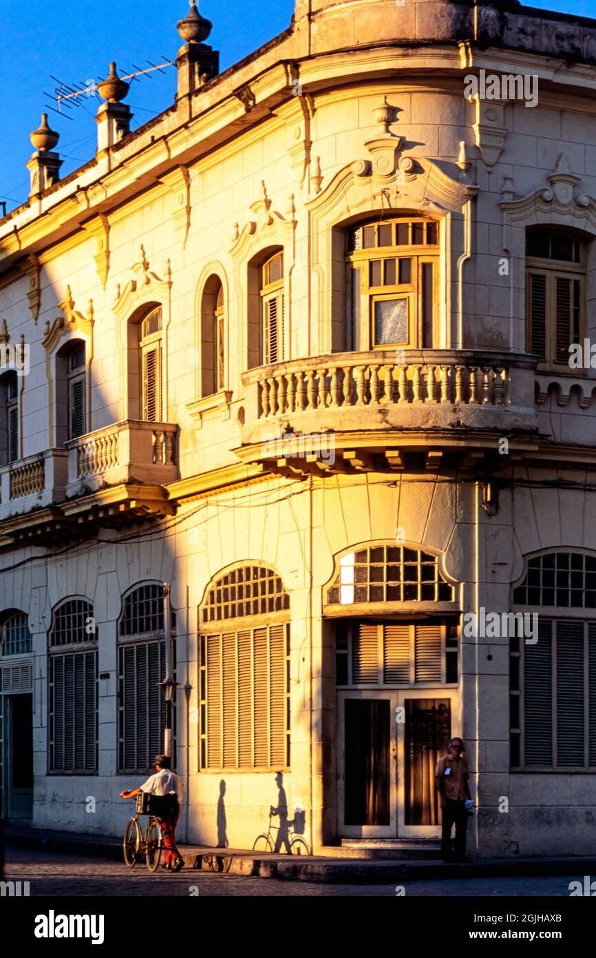 Typical Spanish colonial style building with balcony, and pedestrian, Sancti Spiritus, Cuba Stock Photo