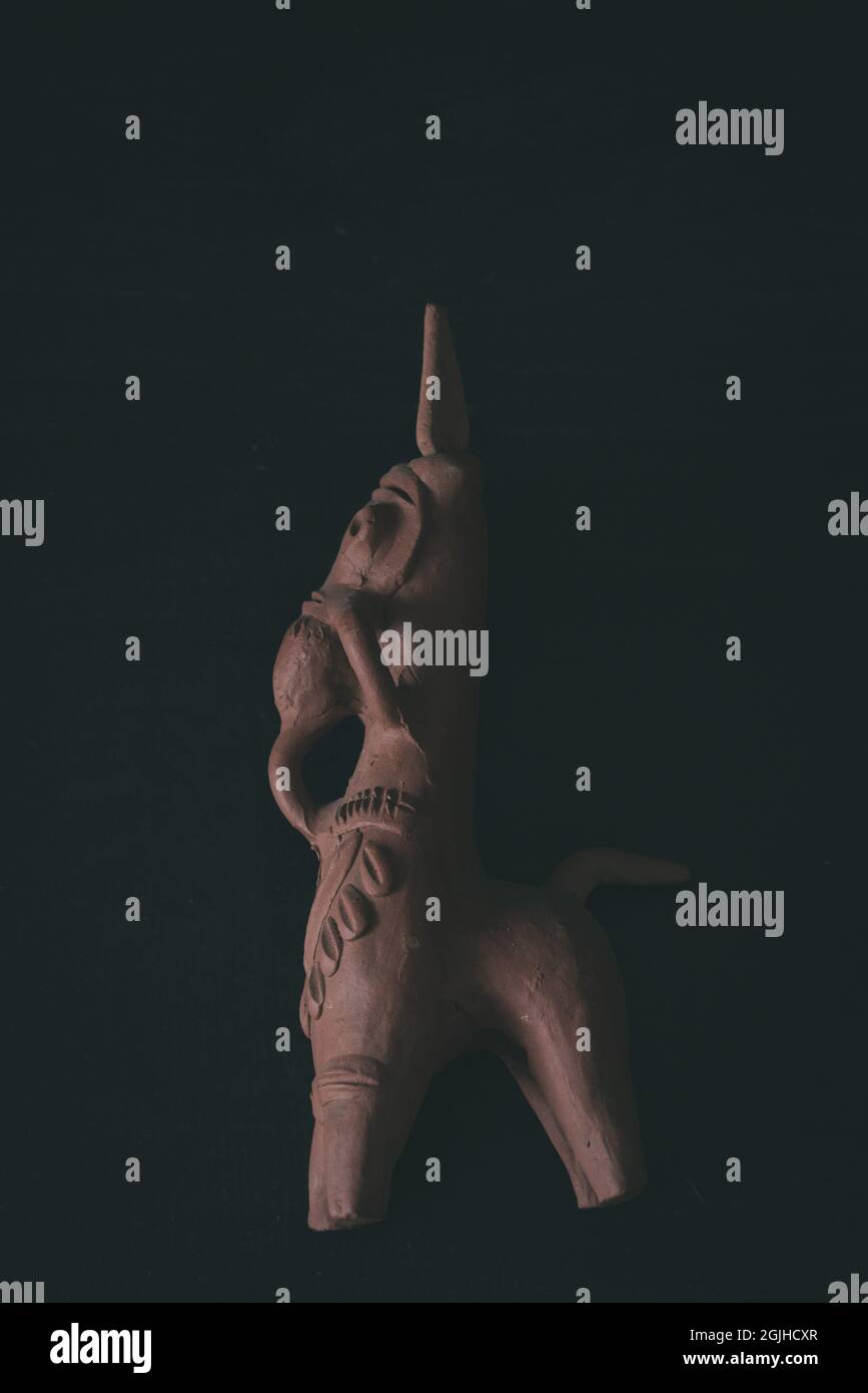 KOLKATA, INDIA - Jun 30, 2021: A vertical shot of the clay Horse of Bankura statue, isolated on a black background Stock Photo