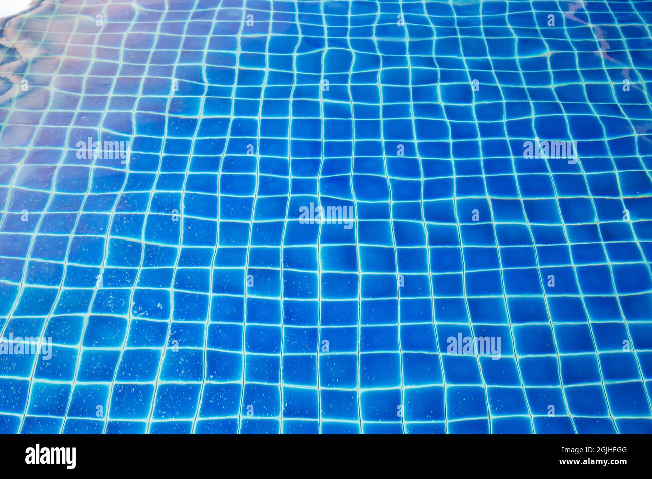 swimming pool sun reflection with blue mosaic background Stock Photo ...