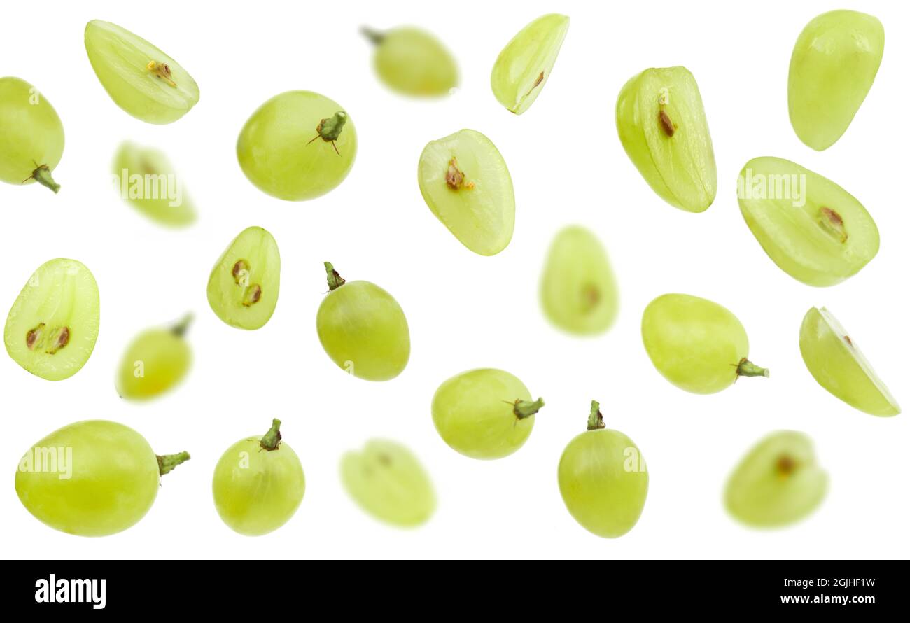 Falling green grape, isolated on white background, selective focus Stock Photo