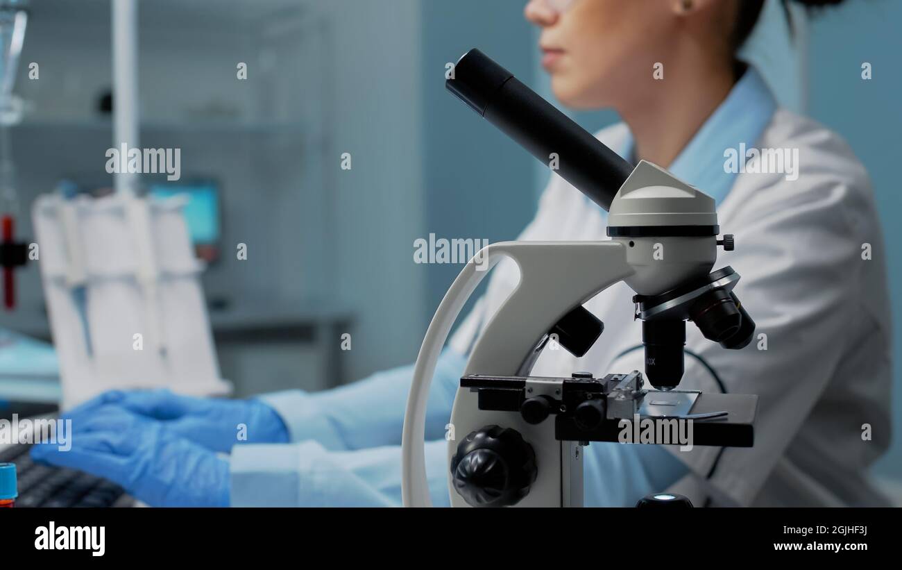 Docter Using Science Scientific woman with microscope tool studying petri dish while using ...