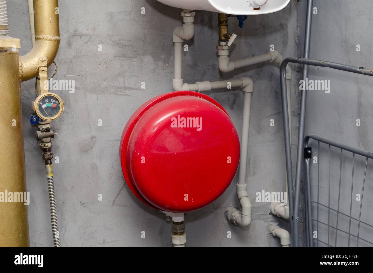 Boiler Room. Red expansion tank, piping, valves, gauge, water he Stock