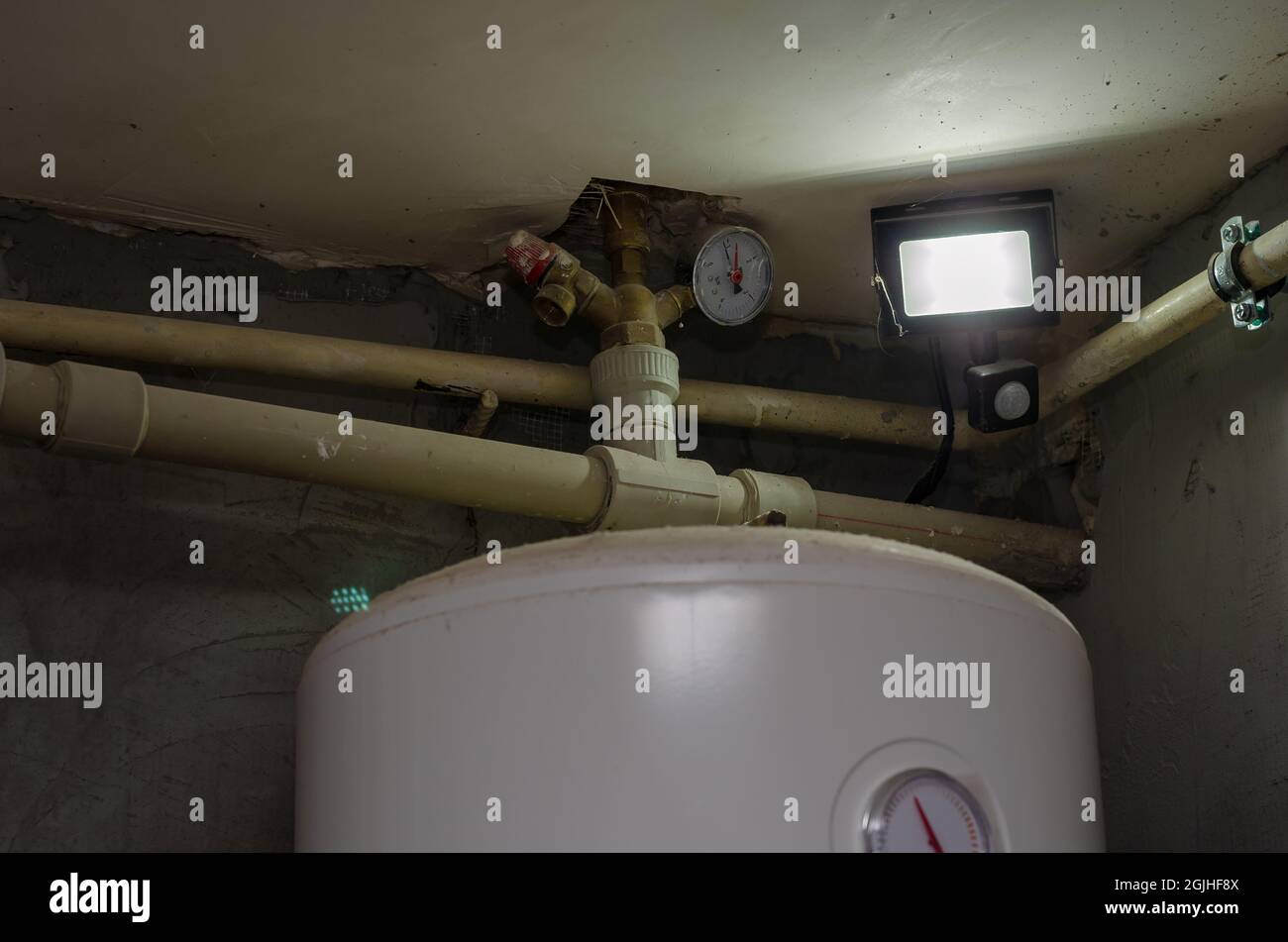 Piping under the ceiling in the boiler room. Spotlight, motion sensor ...