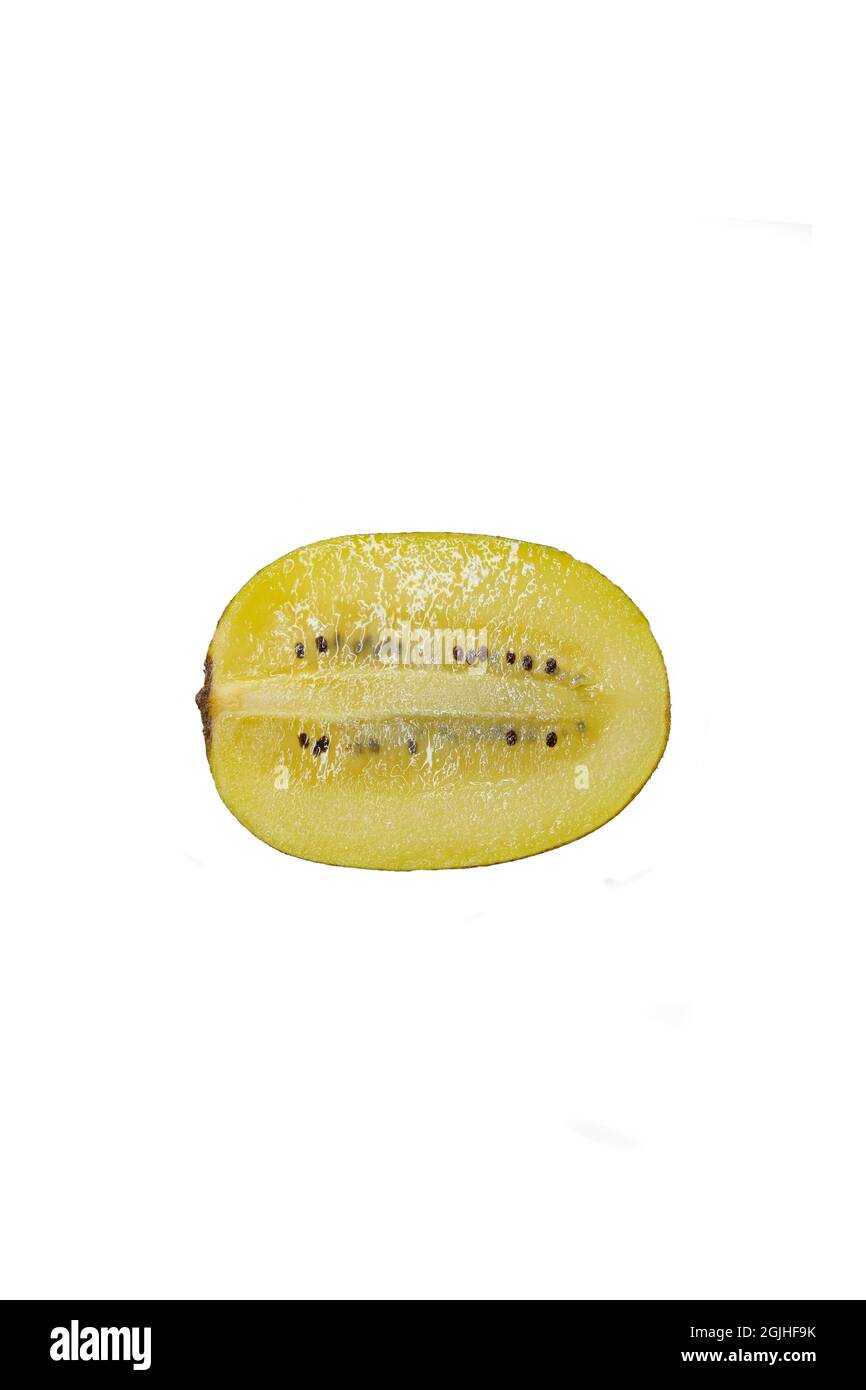 Cross section of a Golden Kiwifruit or Chinese gooseberry (Actinidia chinensis) cut lengthwise, isolated on white background Stock Photo
