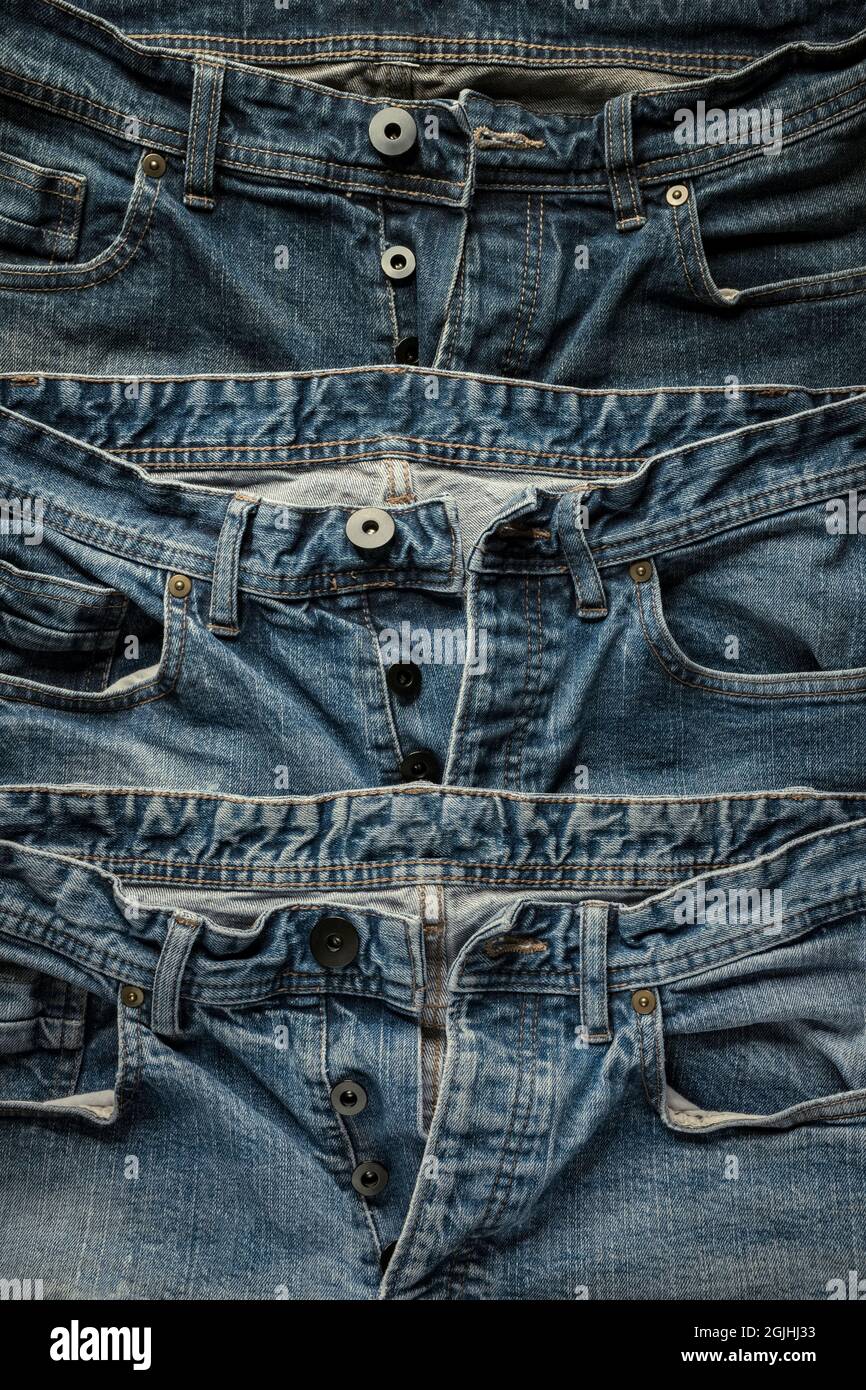 Three pairs of denim jeans. Stock Photo