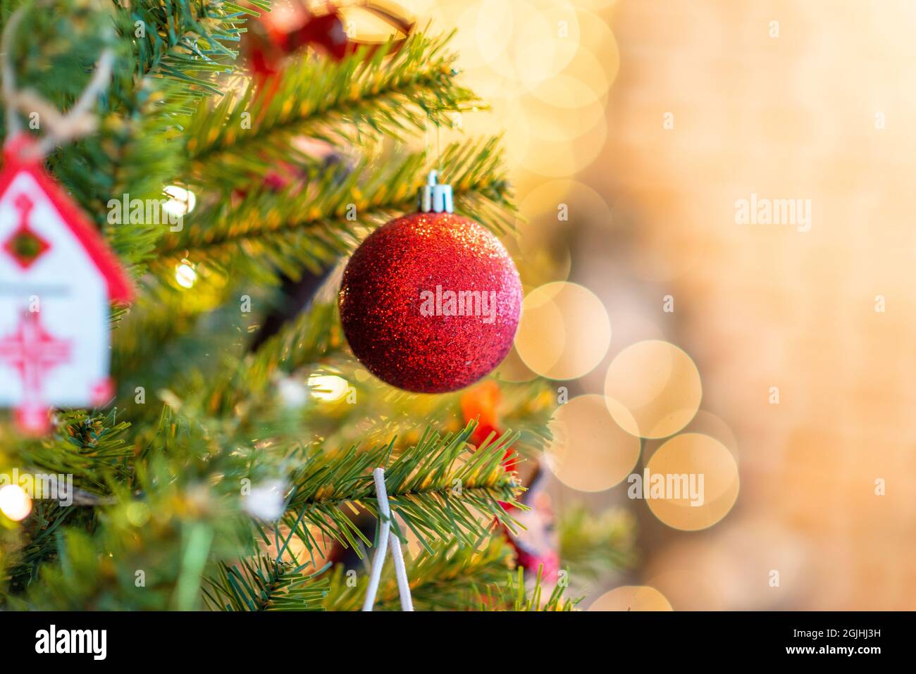 2022. Christmas Tree With Christmas Toys: Wooden Sleigh, Small Bird, Cones, Balls, Colored Lights.concept: New Year, Christmas, Greeting Card, Celebra Stock Photo - Alamy
