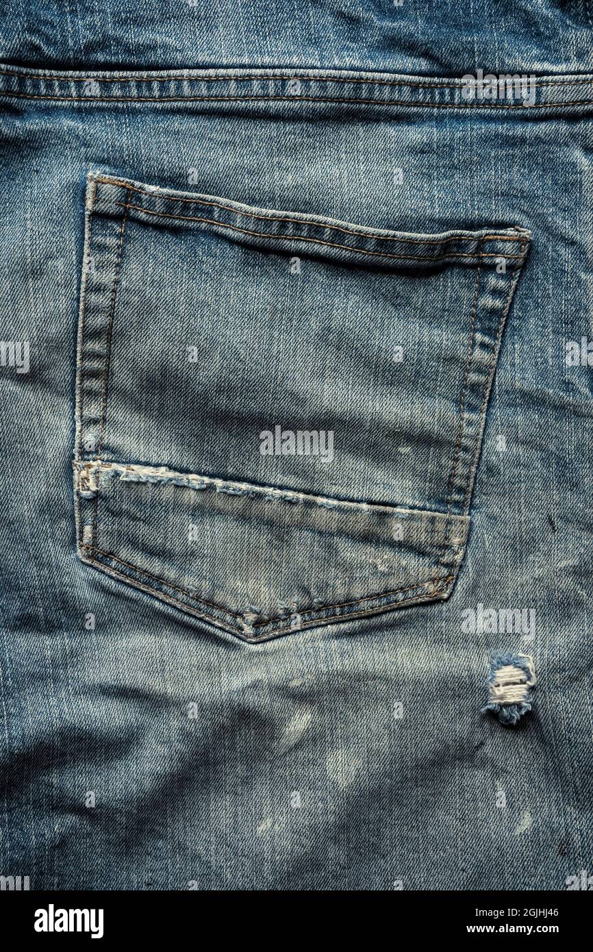 Back pocket of old denim jeans. Stock Photo
