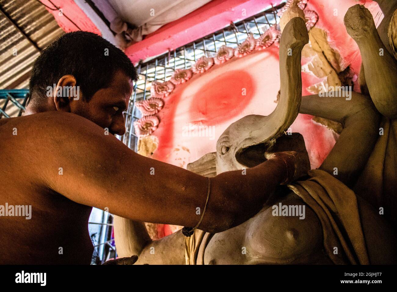 Non Exclusive: BARISHAL, BANGLADESH - SEPTEMBER 9: An artist produces  sculptures of  the Goddess  Durga Puja  at temple as part of preparatives of re Stock Photo
