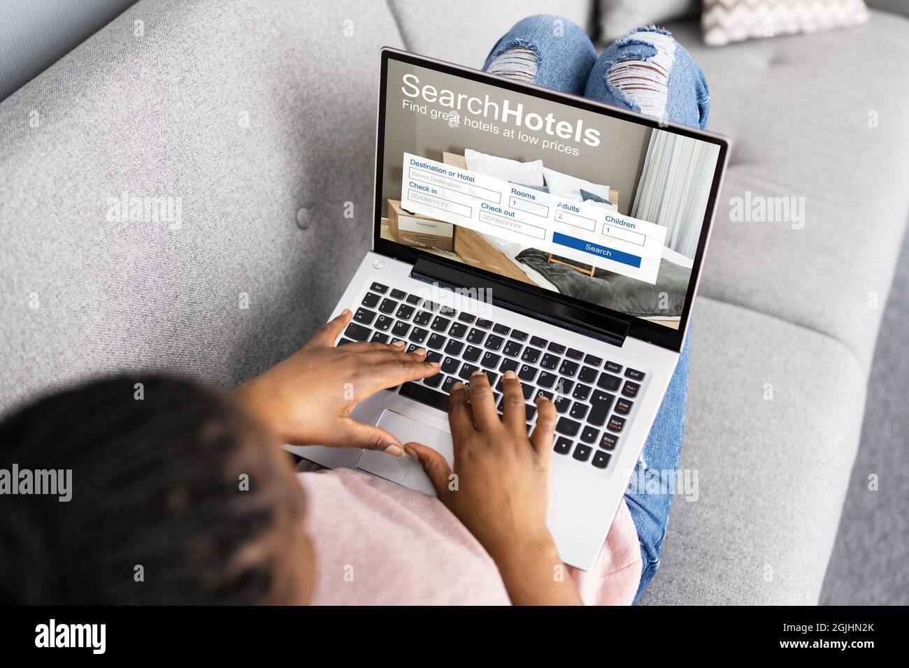 African American Lady Searching Hotel Online On Laptop Stock Photo