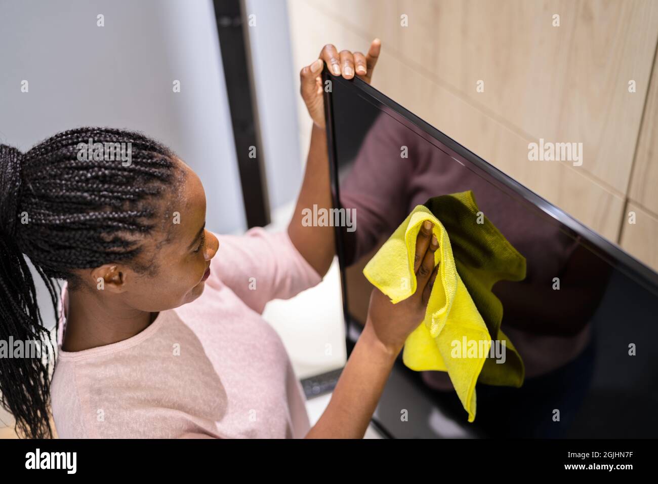 Cleaning TV In Living Room Using Wiping Rag Stock Photo Alamy