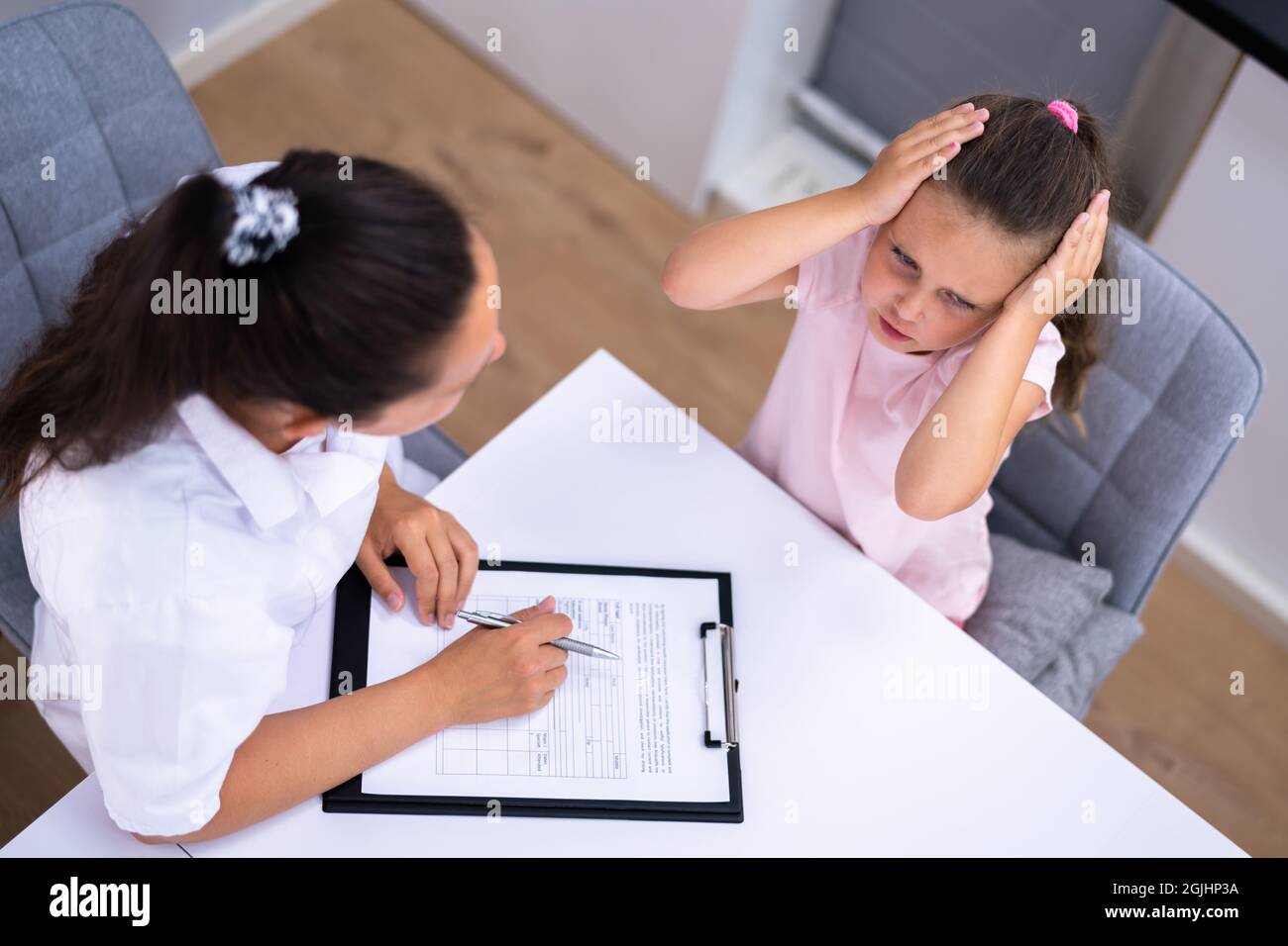 Sick Child Therapy. Therapist Comforting Kid At Hospital Stock Photo