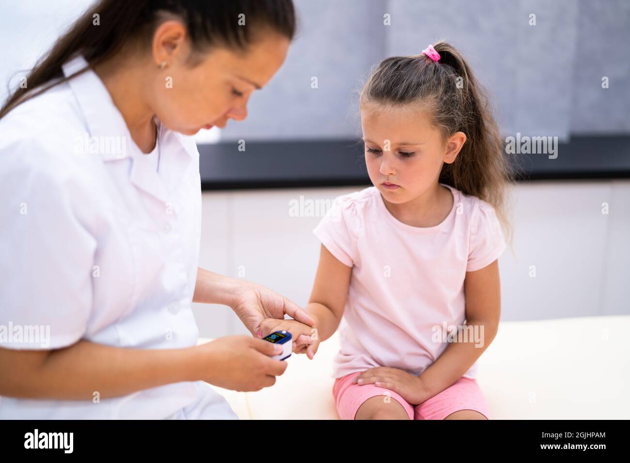 Doctor Checking Child Blood Pulse Using Oximeter Stock Photo Alamy