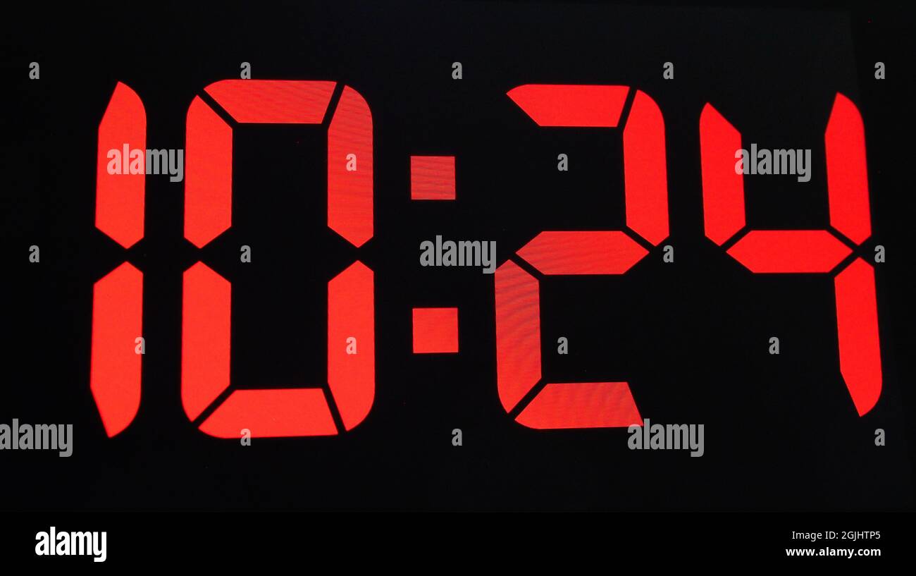 Close-up of a digital clock splay in red showing the time 10:24 AM Stock Photo