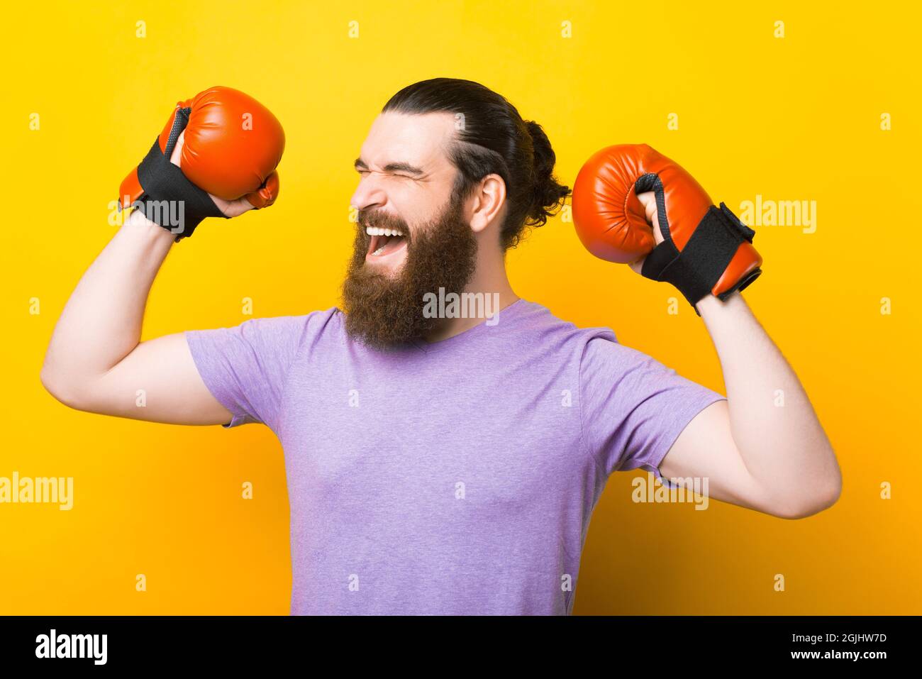 I am the winner. Says a bearded man wearing boxing gloves over yellow
