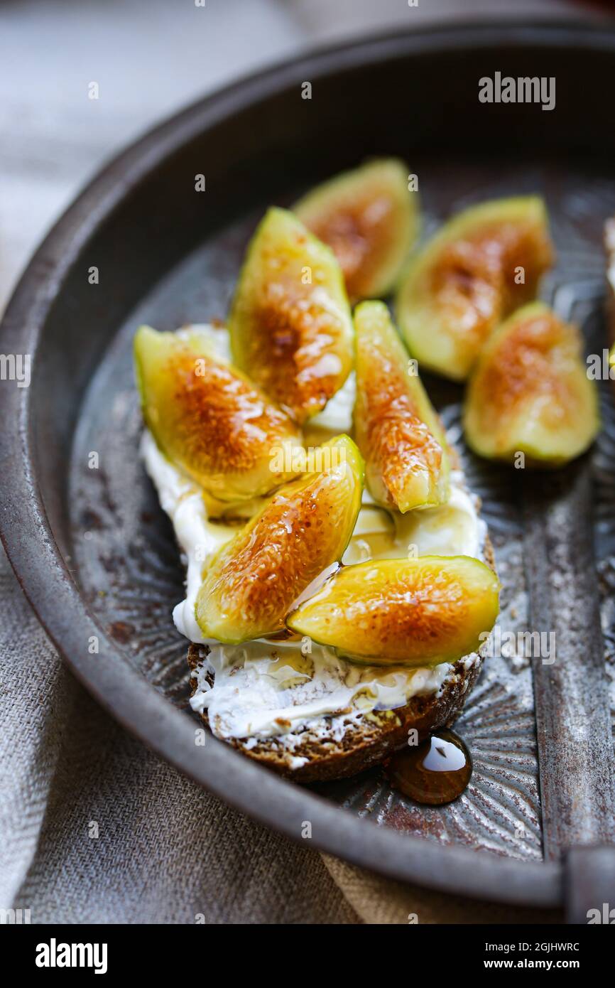 Figs, ricotta and honey toast. The perfect fall appetizer or snack. Stock Photo