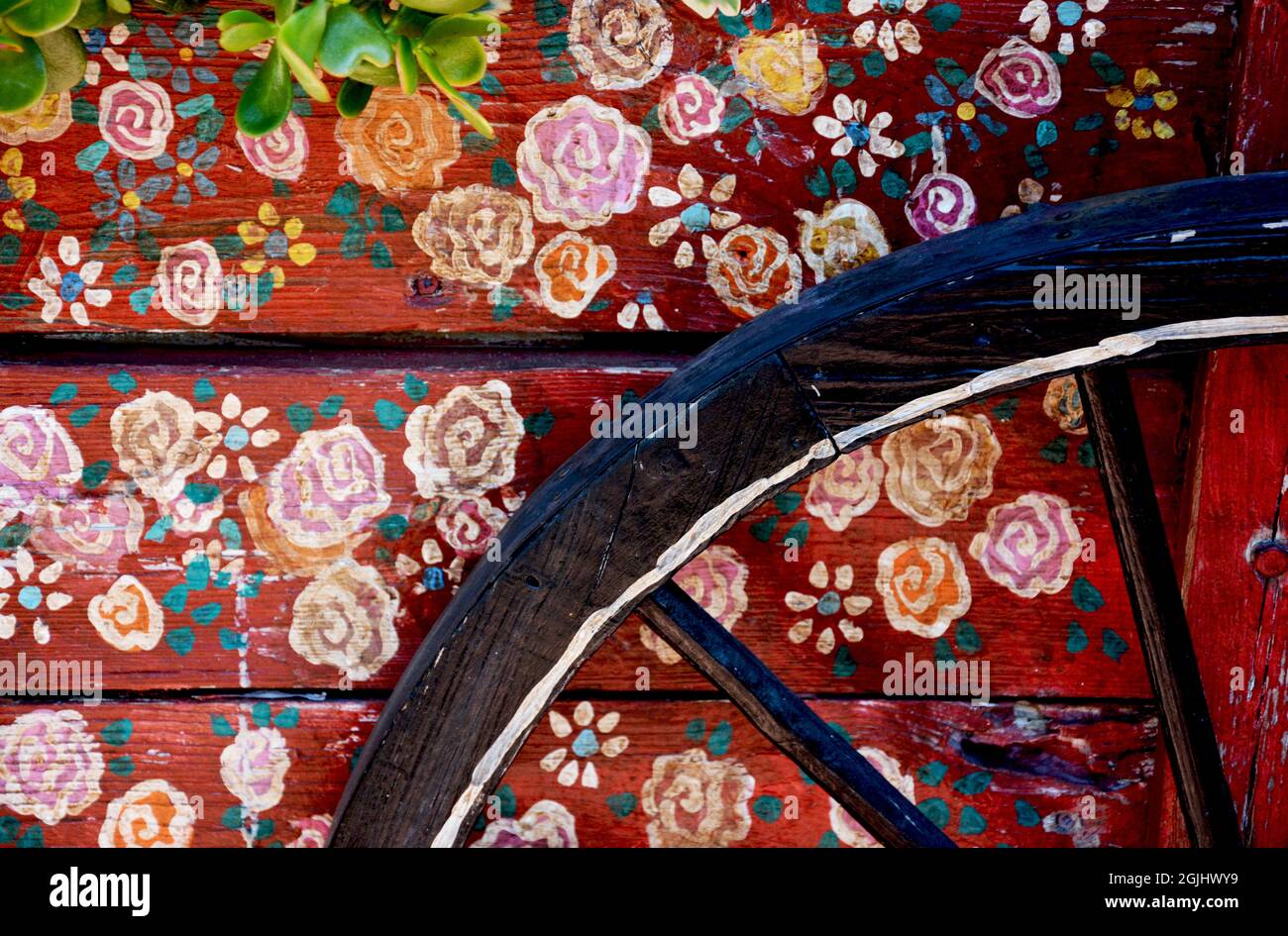 Red, wooden vintage wagon wheel with colourful floral design Stock ...