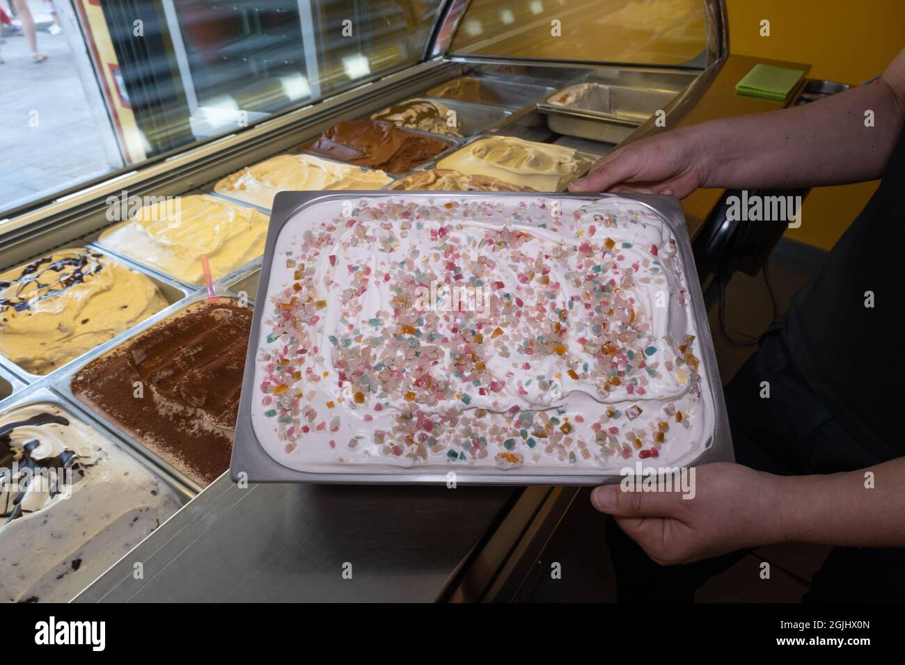 Italian artisan ice cream (Gelato) manufacturing. Serving process in