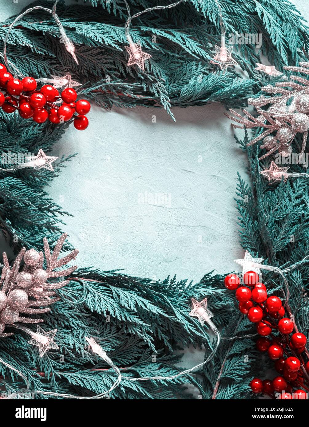 Green fir tree branches frame with star shape Christmas lights Stock ...