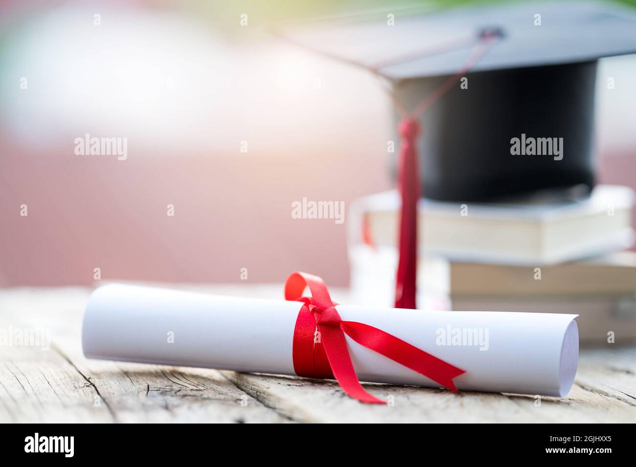 Closeup shot of a graduation cap and diploma degree certificate on a ...