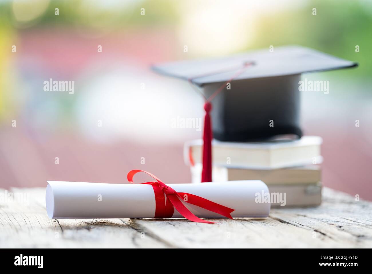 Closeup shot of a graduation cap and diploma degree certificate on a ...