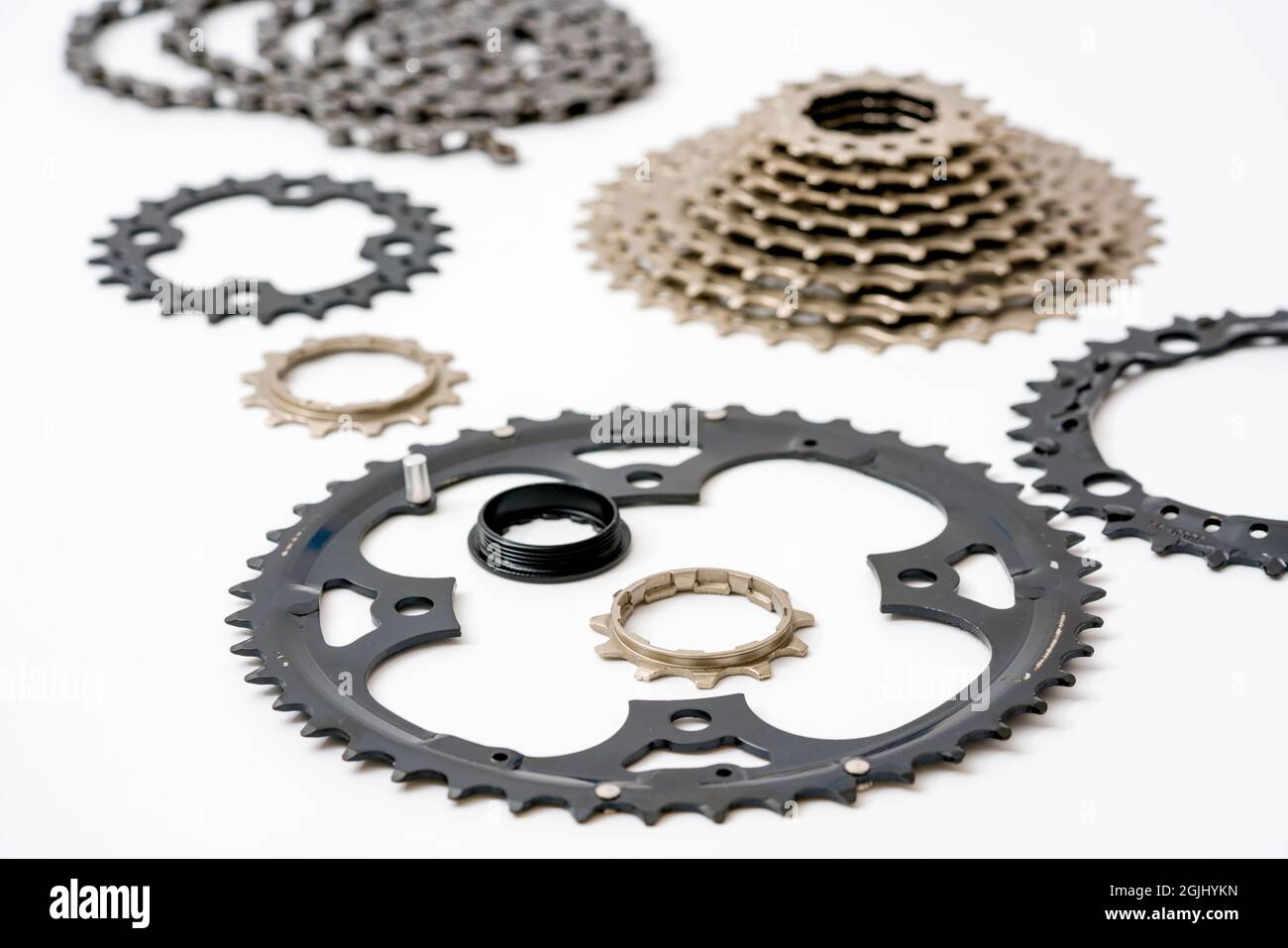 Gears, sprockets and chain of a mountain sports bike on a white