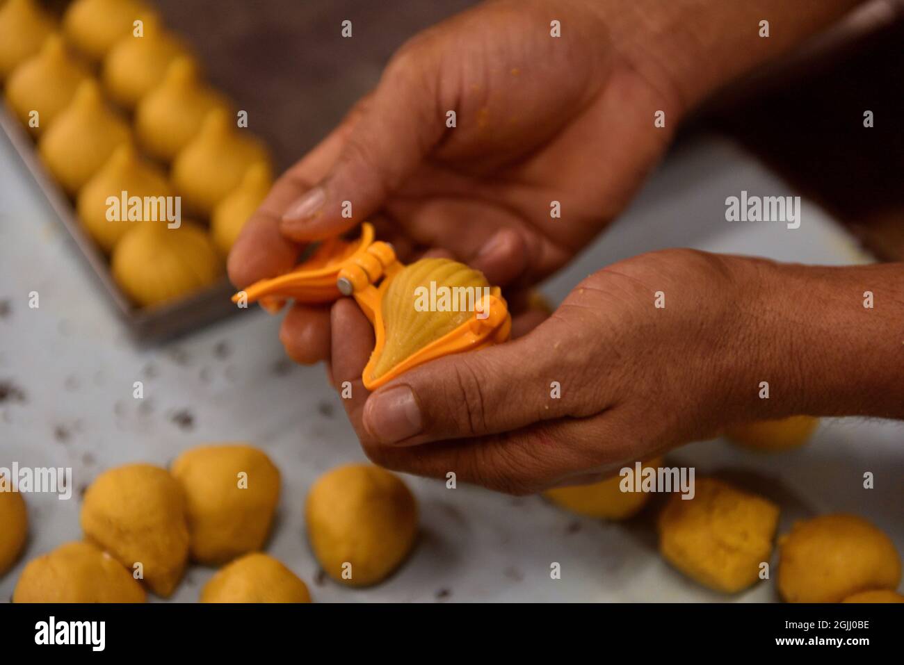 Kolkata, India. 09th Sep, 2021. Khoya modak, to offer the elephant-headed God, Lord Ganesha as bhog. Ganesh Chaturthi, one of the most auspicious festivals in the Hindu calendar, marks the beginning of the 10-day festivities. Also known as Vinayaka Chaturthi, the celebrations begin with bringing home an idol of Lord Ganesha. Food forms an important part of Ganesh Chaturthi celebrations. Among the many desserts to fruits that are part of the festivities, modaks and ladoo. (Photo by Sukhomoy Sen/Pacific Press) Credit: Pacific Press Media Production Corp./Alamy Live News Stock Photo