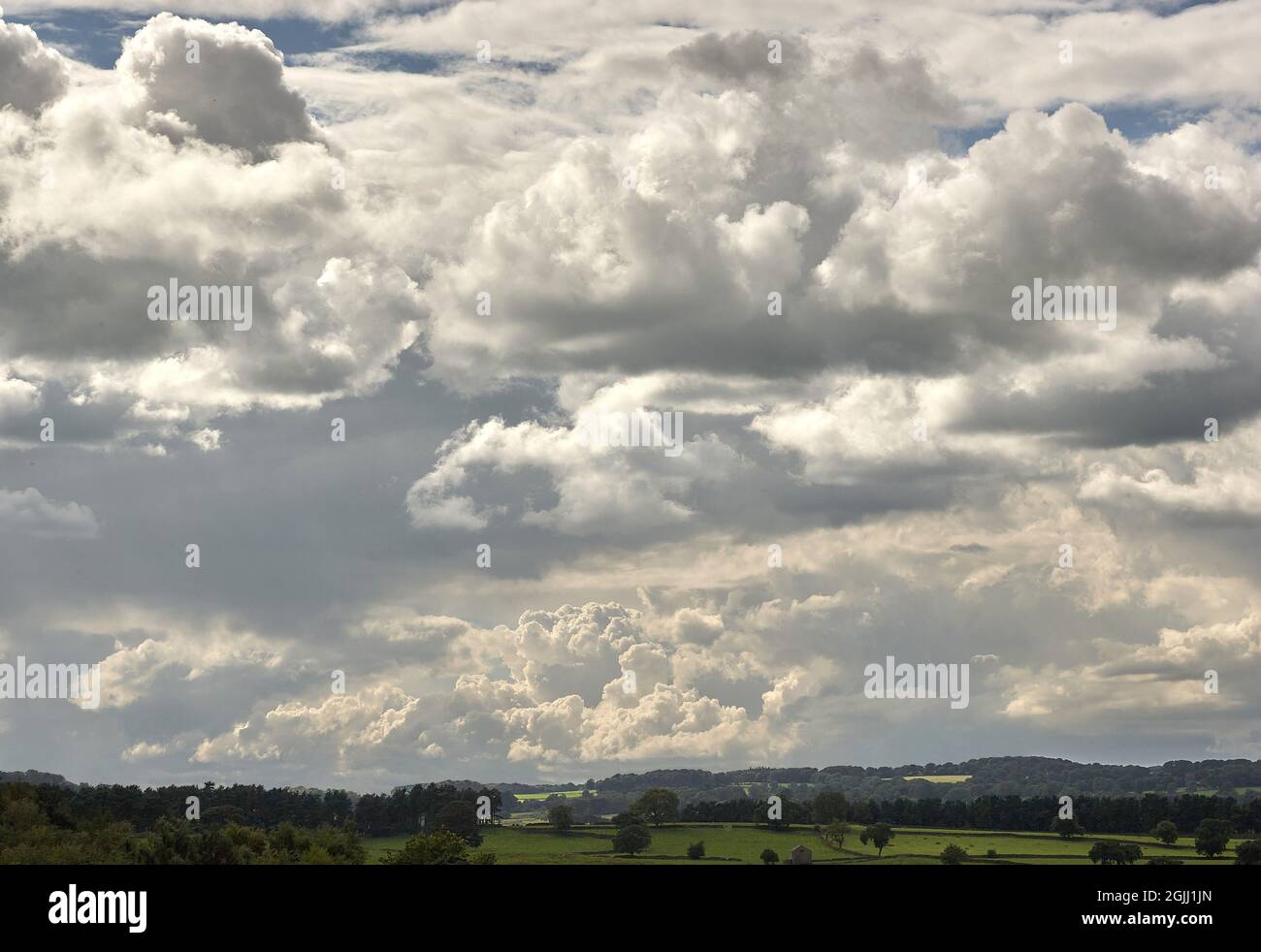 Dramatic cloudscape over Derbyshire hills during unsettled weather conditions - UK Stock Photo