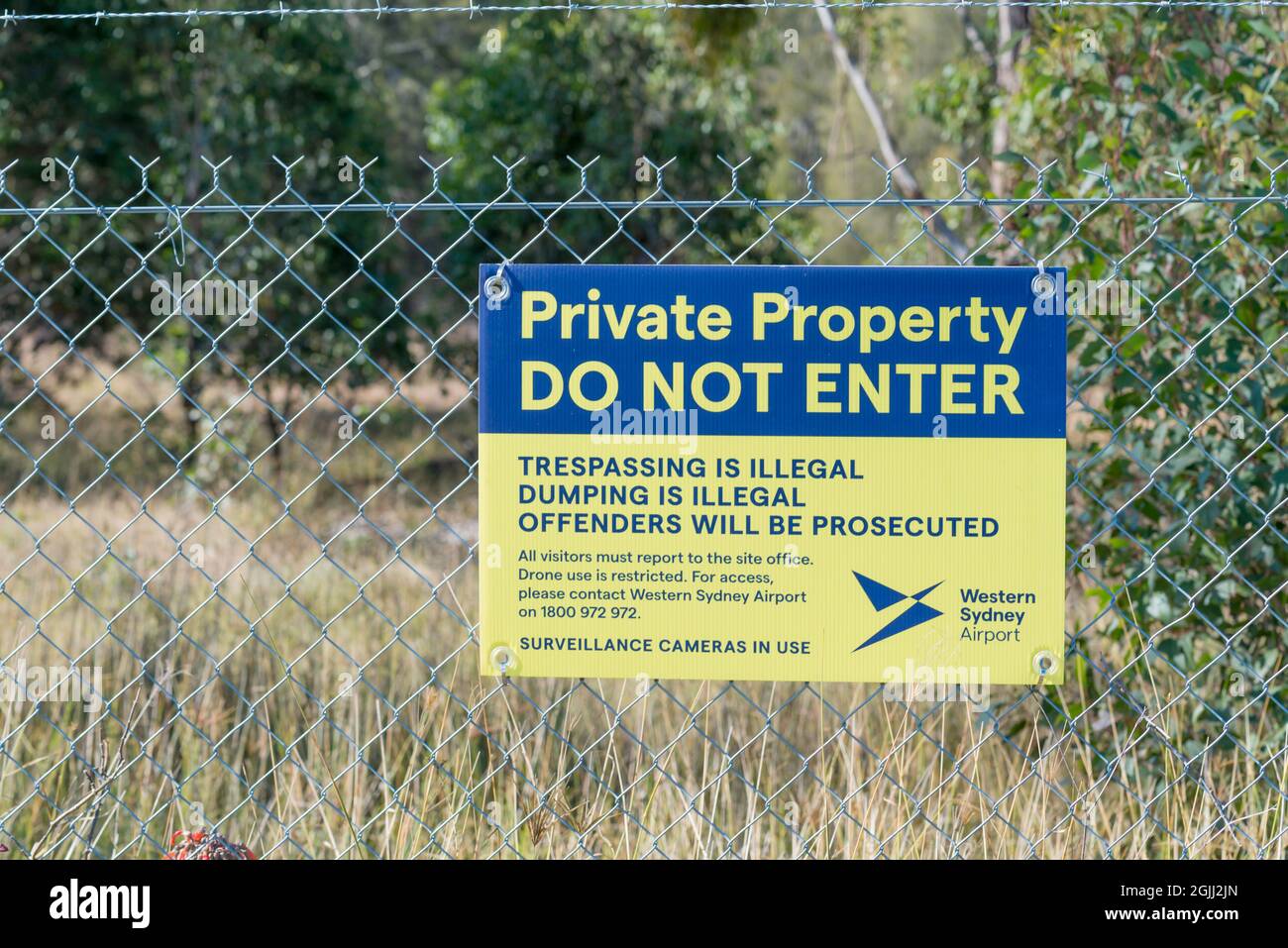 A warning and identification sign on a fence surrounding the new Western Sydney (Nancy Bird Walton) International Airport due to open in 2026 Stock Photo