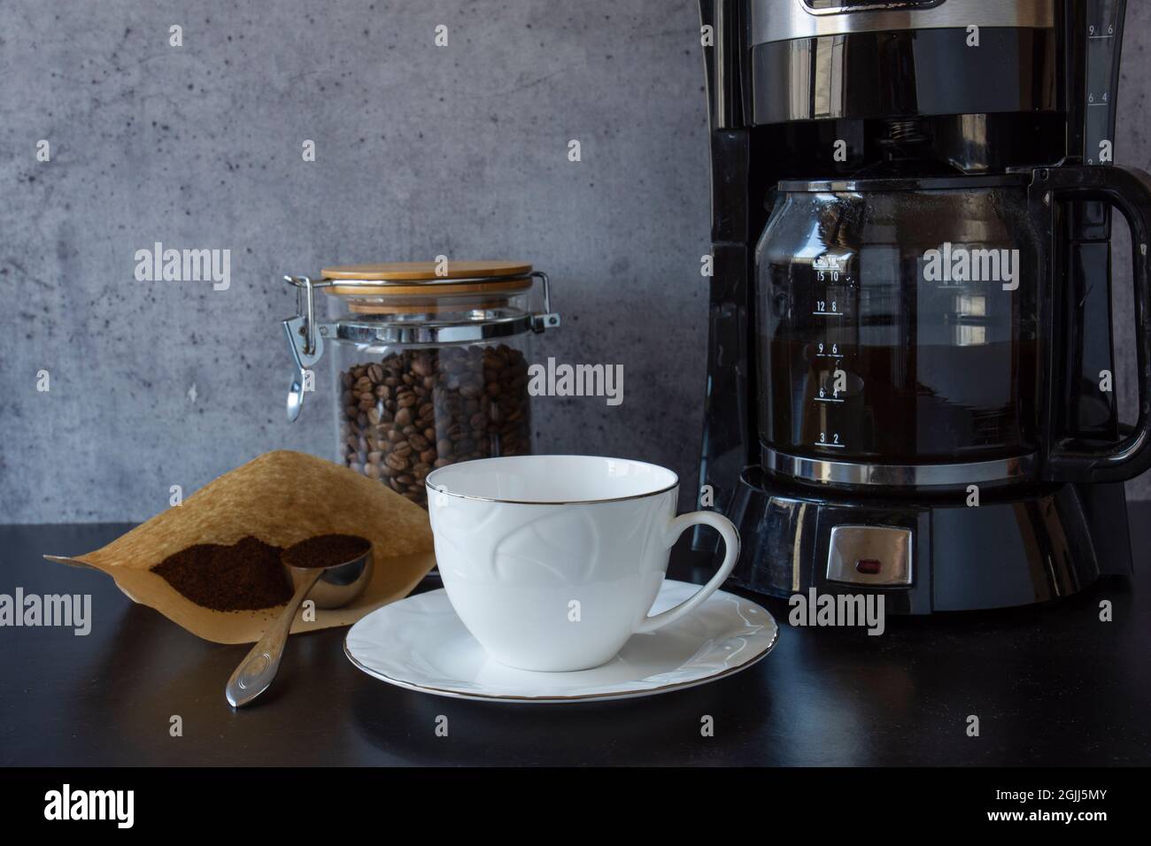 coffee machine, a cup, a jar full of coffee beans and a spoon of turkish coffee Stock Photo