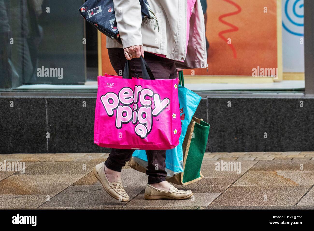 Preston, Lancashire.  UK Weather 10 Sept 2021.  Percy Pig M&S reusable bag;  Shops, shoppers, shopping on a showery day in Preston City Centre.  Credit; MediaWorldImages/AlamyLiveNews Stock Photo