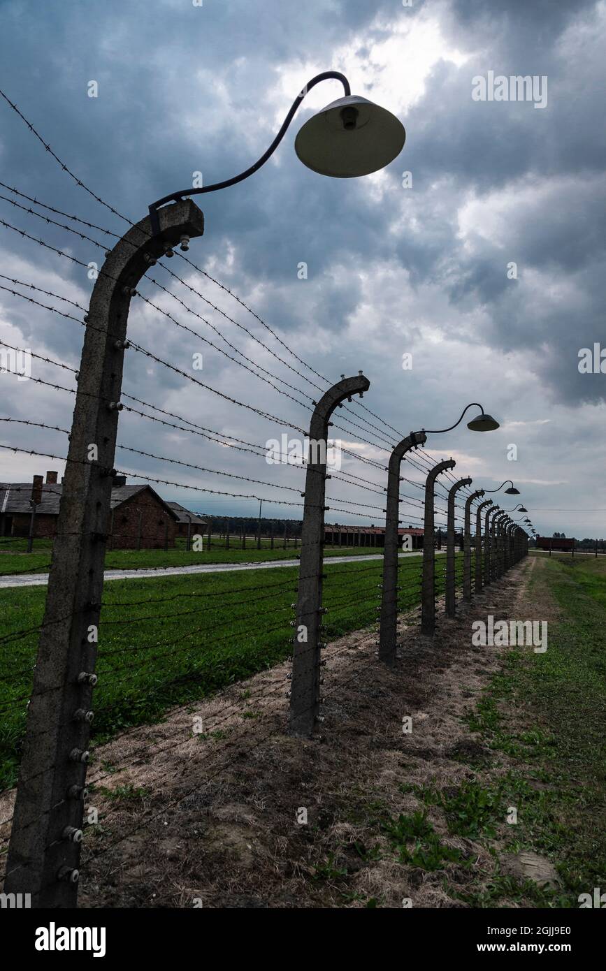 Auschwitz, Poland - August 30, 2018: Electrified fence of the Auschwitz Birkenau concentration camp at sunset, an extermination camp operated by Nazi Stock Photo