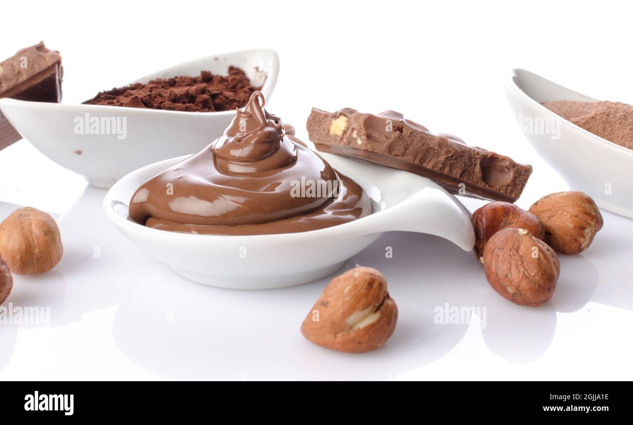 Sweet chocolate hazelnut spread with cocoa powder, isolated on white