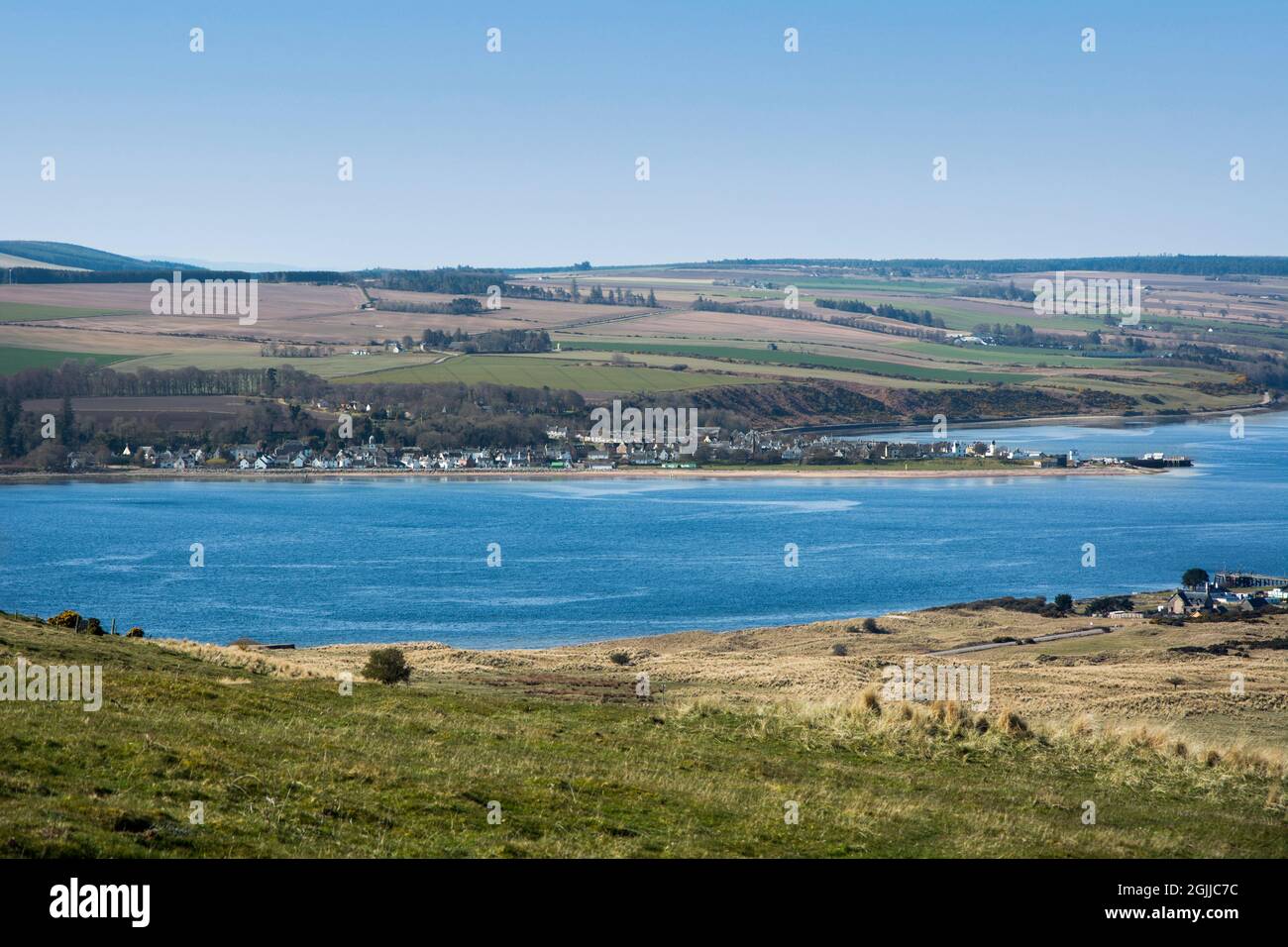 The small Scottish highland village of Cromarty nestles at the shore of the Black Isle with the Cromarty Firth Stock Photo
